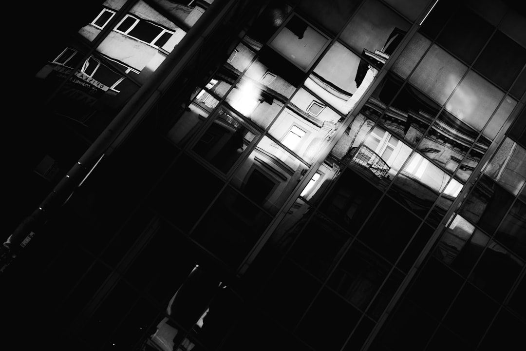 Reflections on a modern building in black and white.