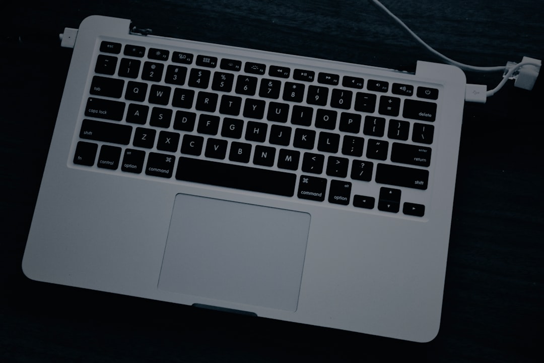 a white laptop computer sitting on top of a table