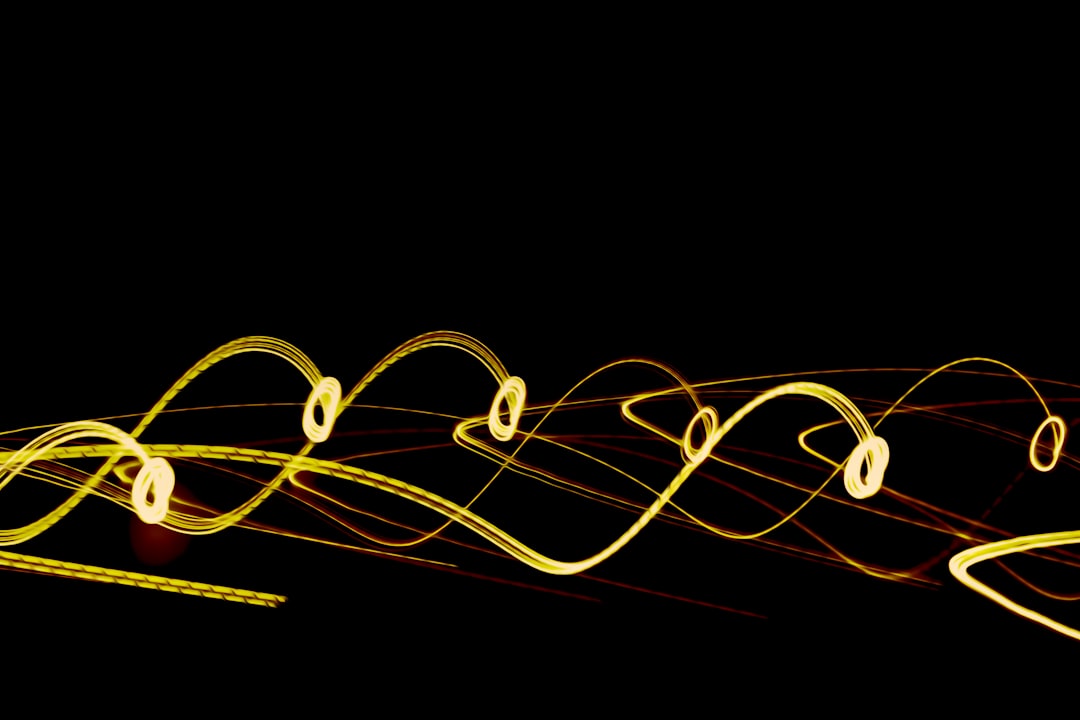 a long exposure photo of yellow lines on a black background